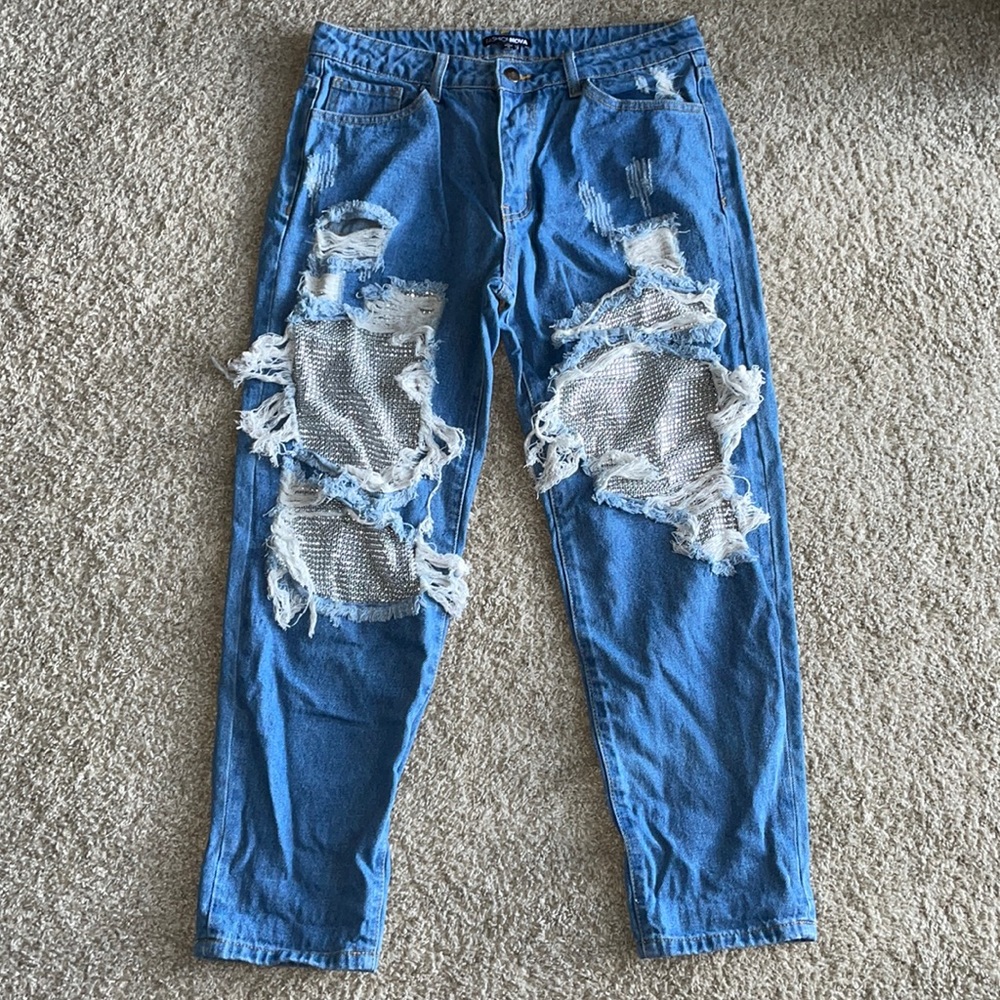 Rip blue jeans with glam